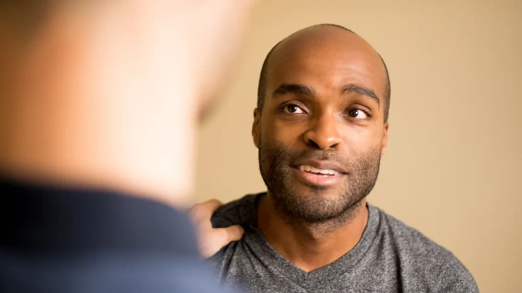 Patient speaking with practitioner during an acupuncture consultation