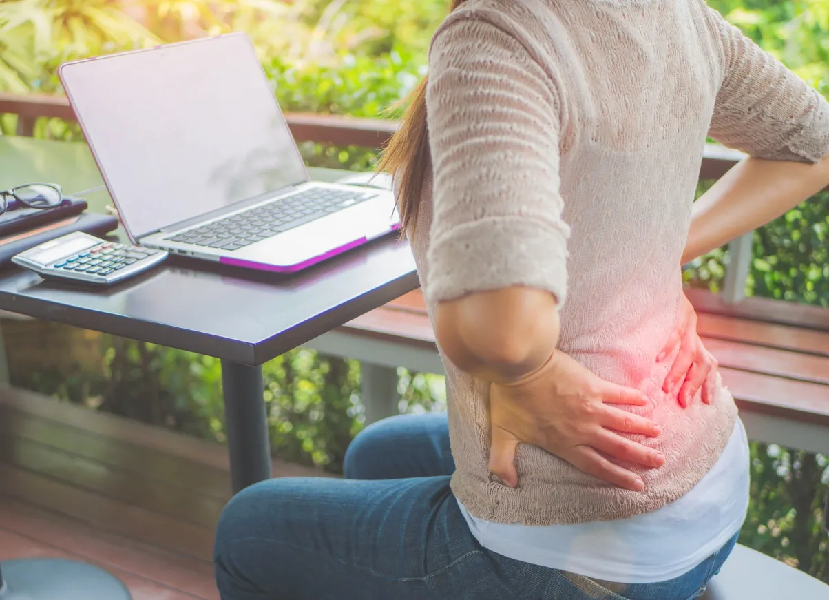 Adult holding the lower back with radiating sciatic pain