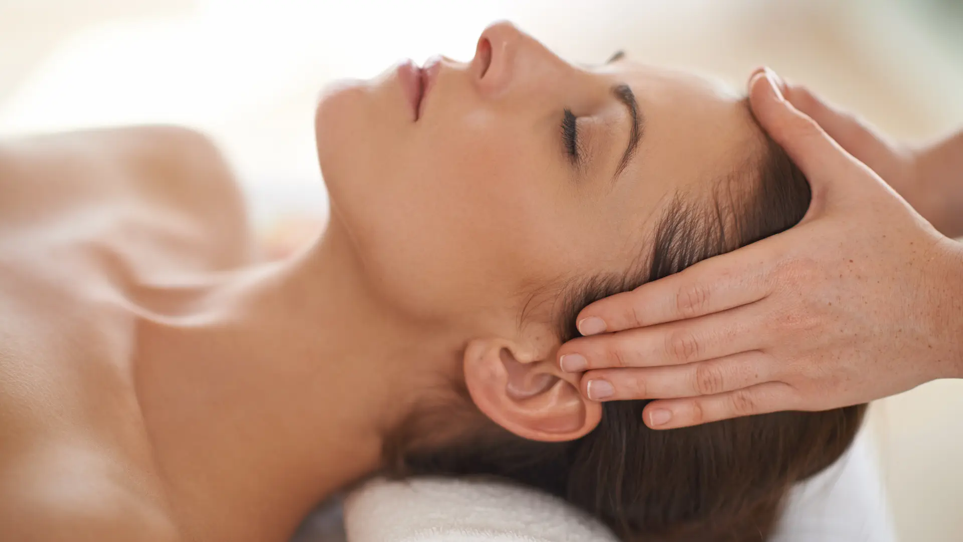 Practitioner performing dry needling on forehead trigger points during a therapeutic session at Messina Acupuncture