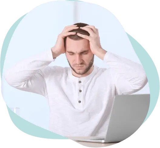 Man holding head in pain from headache and stress at work, treatable with acupuncture in East Setauket NY