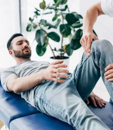 Practitioner assisting patient with knee rehabilitation therapy in East Setauket NY