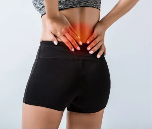 Woman holding lower back in pain with highlighted spine, showing acupuncture treatment benefits in East Setauket NY
