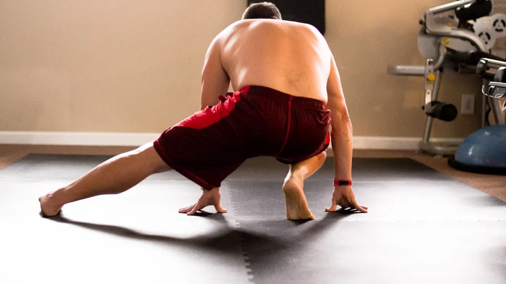 Patient performing a deep stretch as part of rehabilitation or mobility therapy session