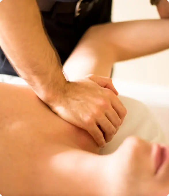 Therapist performing shoulder and arm massage therapy for pain relief in East Setauket NY