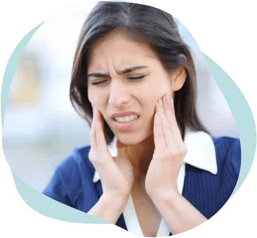 Woman holding her jaw in pain from TMJ disorder, treatable with acupuncture in East Setauket NY