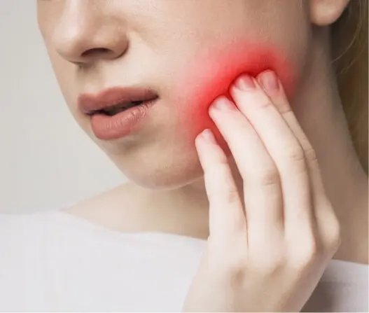 Close-up of woman with highlighted jaw pain from TMJ disorder, treatable with acupuncture in East Setauket NY