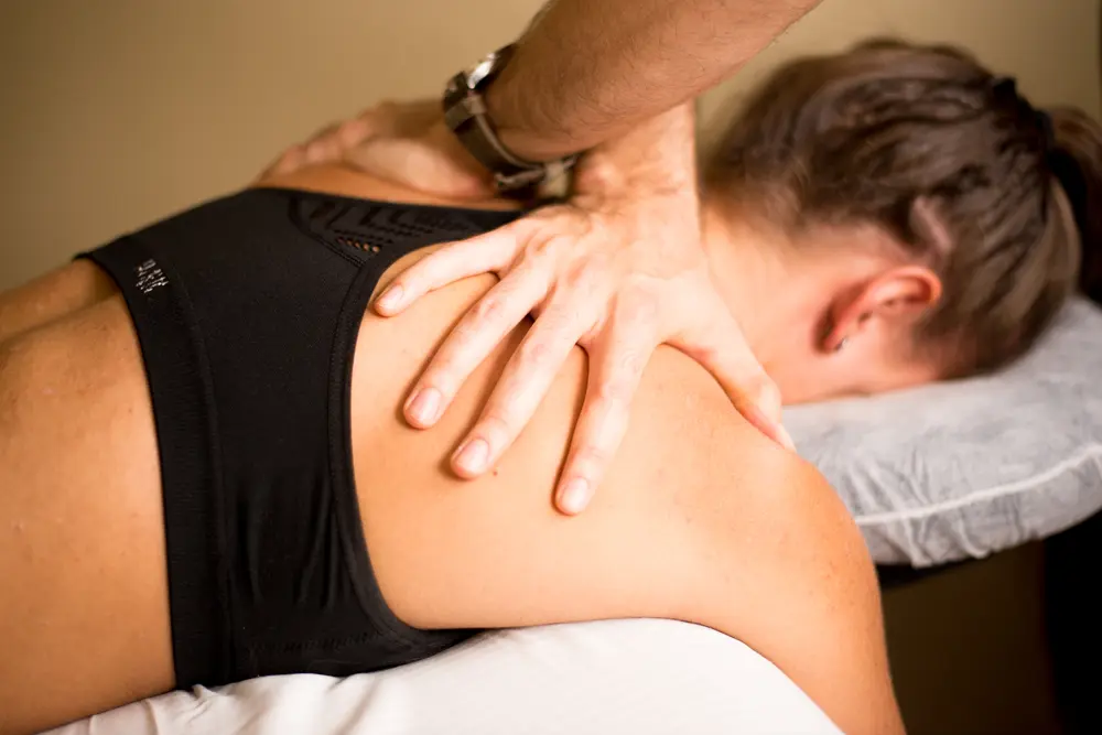 Therapist performing upper back and shoulder massage for tension relief in East Setauket NY