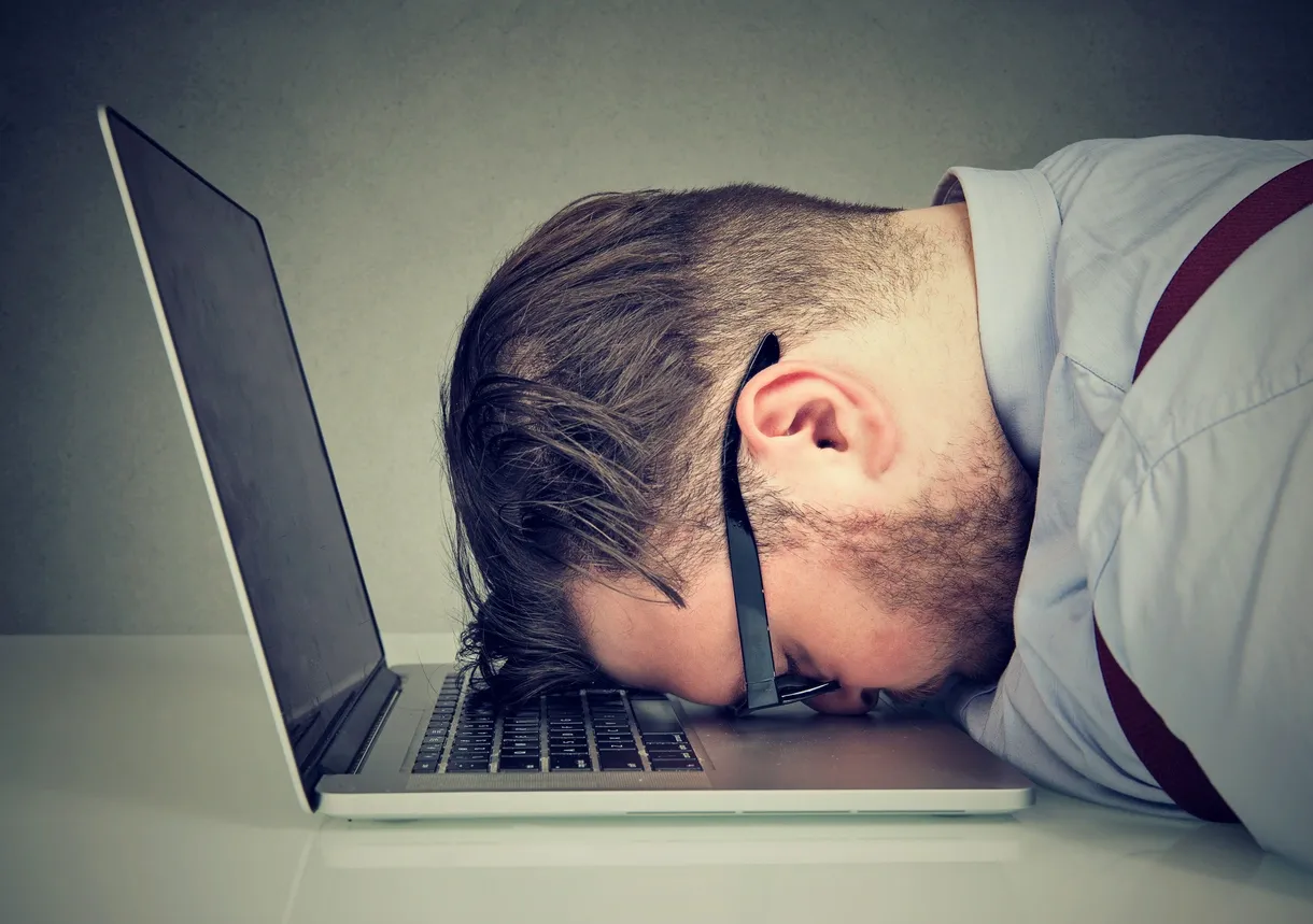 Office worker with tension headache from screen fatigue